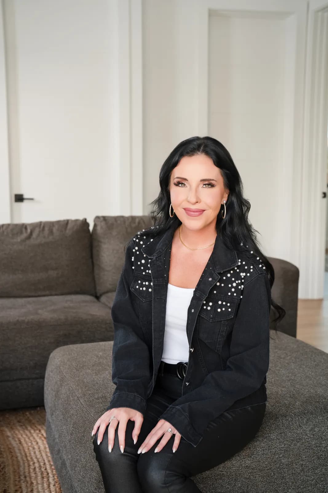 Danielle seated on a sofa
